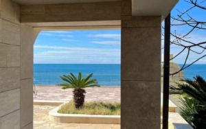 Stunning Ulcinj Montenegro property: ocean views through a stone arch, palm patio, by Ekosphere on montenegro-listings.me.