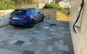 Modern Ulcinj property with EV charger, tiled drive, luxury SUV, greenery—exclusive from Ekosphere Montenegro-Listings.me.