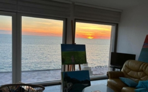 Stunning Ulcinj sea-view living room with sunset vistas, bright windows, art accents. Exclusive Ekosphere DOO listing on montenegro-listings.me.