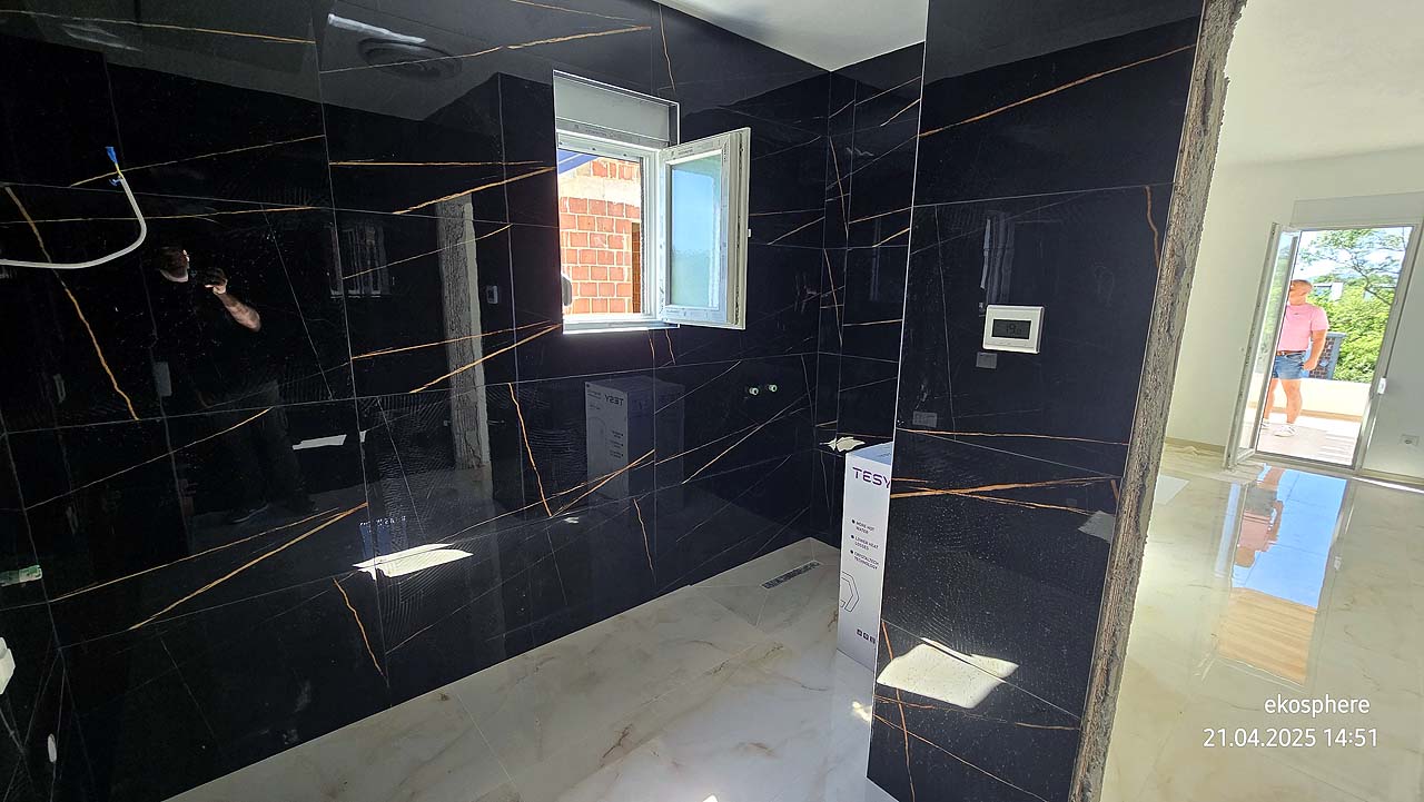 Under-construction Ulcinj property with sleek black tiled walls & sunlit space&mdash;prime investment via montenegro-listings.me by Ekosphere.