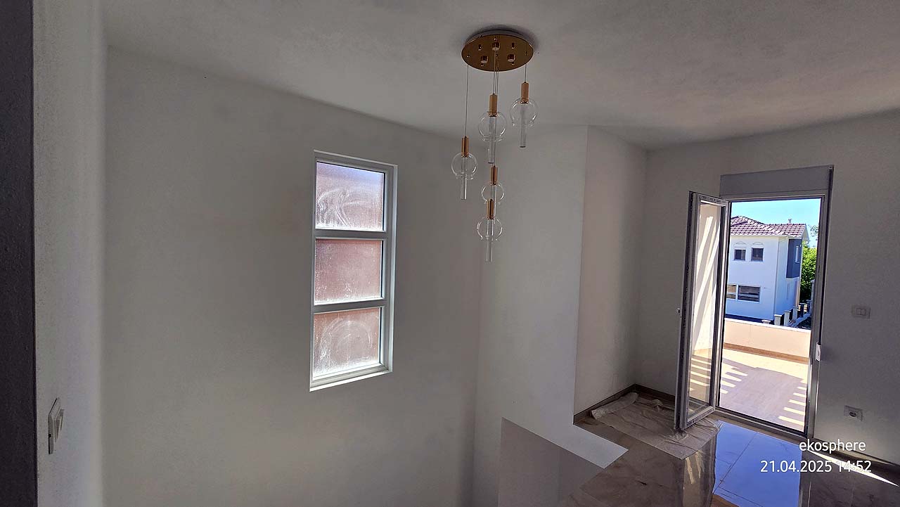 Modern stairwell with white walls, ceiling light, balcony access and Ulcinj views&mdash;ideal property on montenegro-listings.me by ekosphere doo.