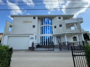 Villa Millaris: Modern 3-story luxury home in Ulcinj, Montenegro with blue-tinted windows, balconies, garage—exclusive at montenegro-listings.me by ekosphere doo.