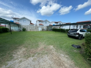 Prime Ulcinj real estate: modern homes with white walls, red roofs, carports, and green parking. Exclusive on montenegro-listings.me by ekosphere doo.
