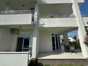 Modern white building in Ulcinj, Montenegro with balconies and patio, premium Ekosphere design. Exclusive at montenegro-listings.me.
