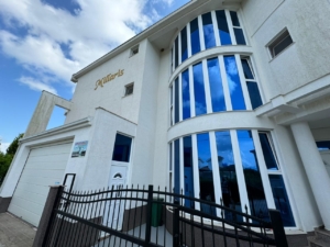 Contemporary “Millaris” property in Ulcinj, Montenegro—garage, modern design, blue windows. Listed by montenegro-listings.me/ekosphere doo.