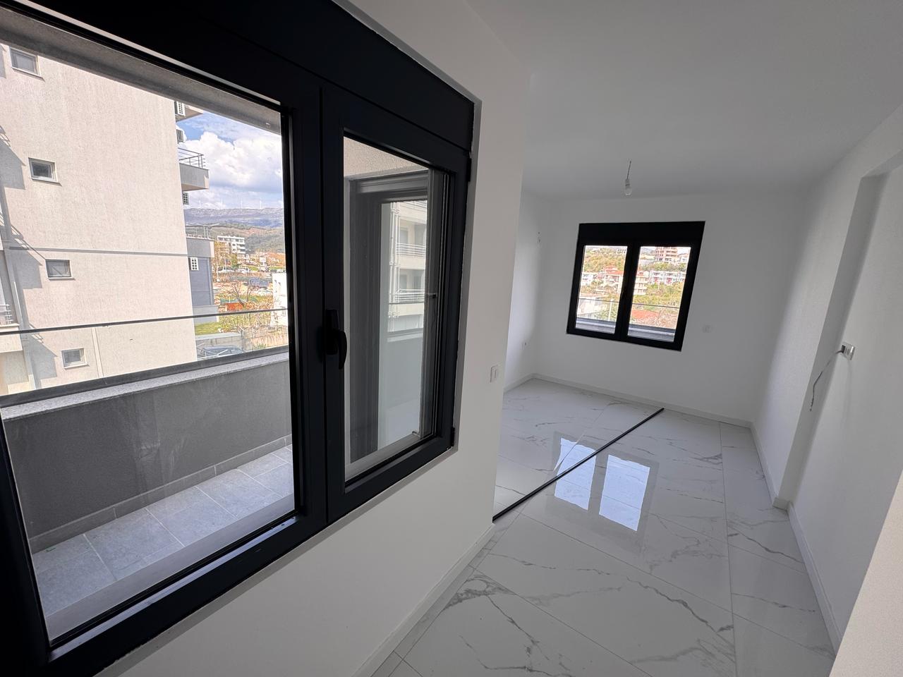 Spacious, sunlit room with white walls, marble floors, balcony views&mdash;prime Ulcinj real estate from montenegro-listings.me by Ekosphere.