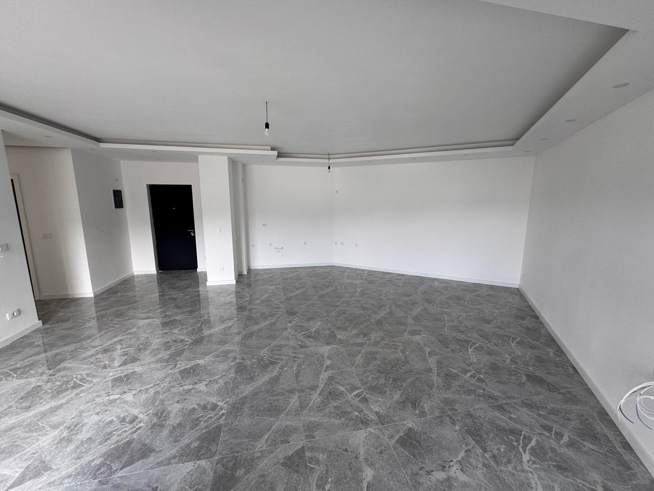 Discover a prime Ulcinj, Montenegro property: modern room with white walls, marbled tiles, & ekosphere style&mdash;exclusive at montenegro-listings.me.