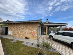 Charming Ulcinj home for sale: stone exterior, dark tile roof, carport, landscaped yard. Top investment at montenegro-listings.me by ekosphere doo.