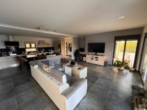 Stunning Ulcinj modern open-plan living with gray tiled floors, elegant sofa, top finishes—ideal Montenegro investment by ekosphere doo.
