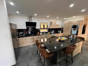 Stylish Ulcinj kitchen: wood cabinets, black appliances, spacious island—exclusive on montenegro-listings.me by Ekosphere doo.