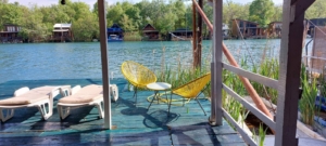 Stunning riverside deck in Ulcinj, Montenegro with yellow chairs and serene river views—exclusive on montenegro-listings.me by Ekosphere doo.
