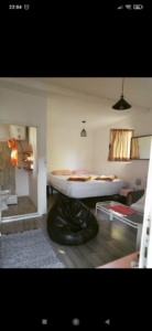 Bright Ulcinj bedroom with double bed, wood floors, and bath access—ideal Montenegro property by Ekosphere on montenegro-listings.me.
