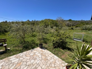 Charming stone patio with lush yard views in Ulcinj—prime Montenegro investment. Exclusive on montenegro-listings.me by ekosphere doo.
