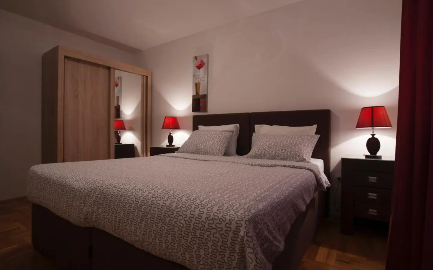 Modern Ulcinj bedroom: elegant gray bedding, stylish d&eacute;cor, and ample storage&mdash;ideal Montenegro real estate by Ekosphere on montenegro-listings.me.