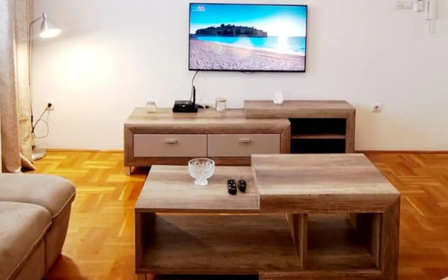 Stunning Ulcinj Montenegro property: modern living room, sleek TV, stylish wood accents, ideal investment by ekosphere doo on montenegro-listings.me.