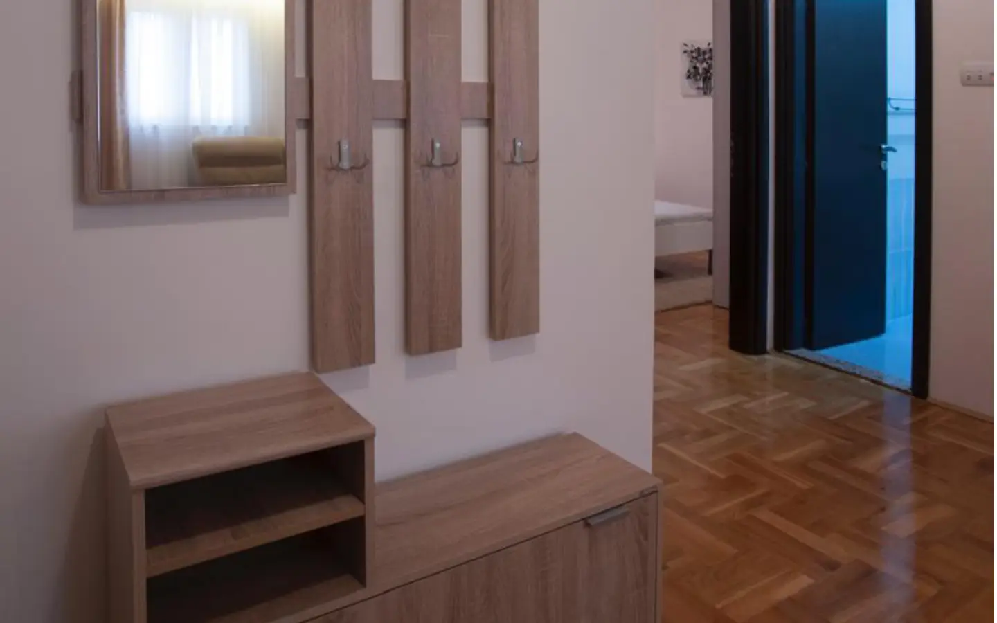 Elegant Ulcinj hallway with parquet floors, mirror, storage&mdash;ideal for property investment. Explore at montenegro-listings.me by ekosphere doo.
