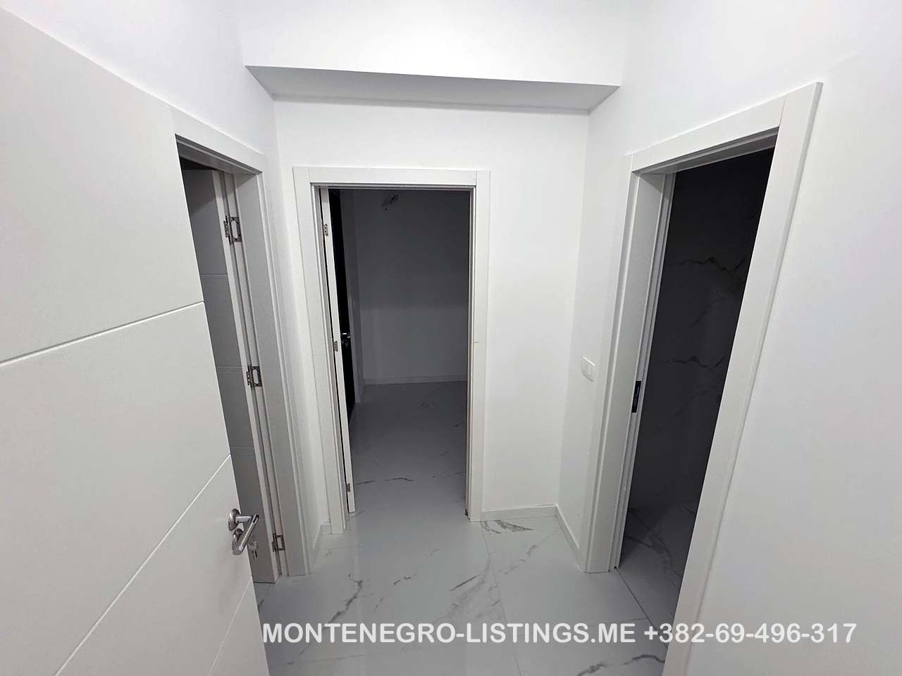 Spacious white hallway with 3 open doorways, marble floors&mdash;prime Ulcinj real estate by montenegro-listings.me, ekosphere doo.