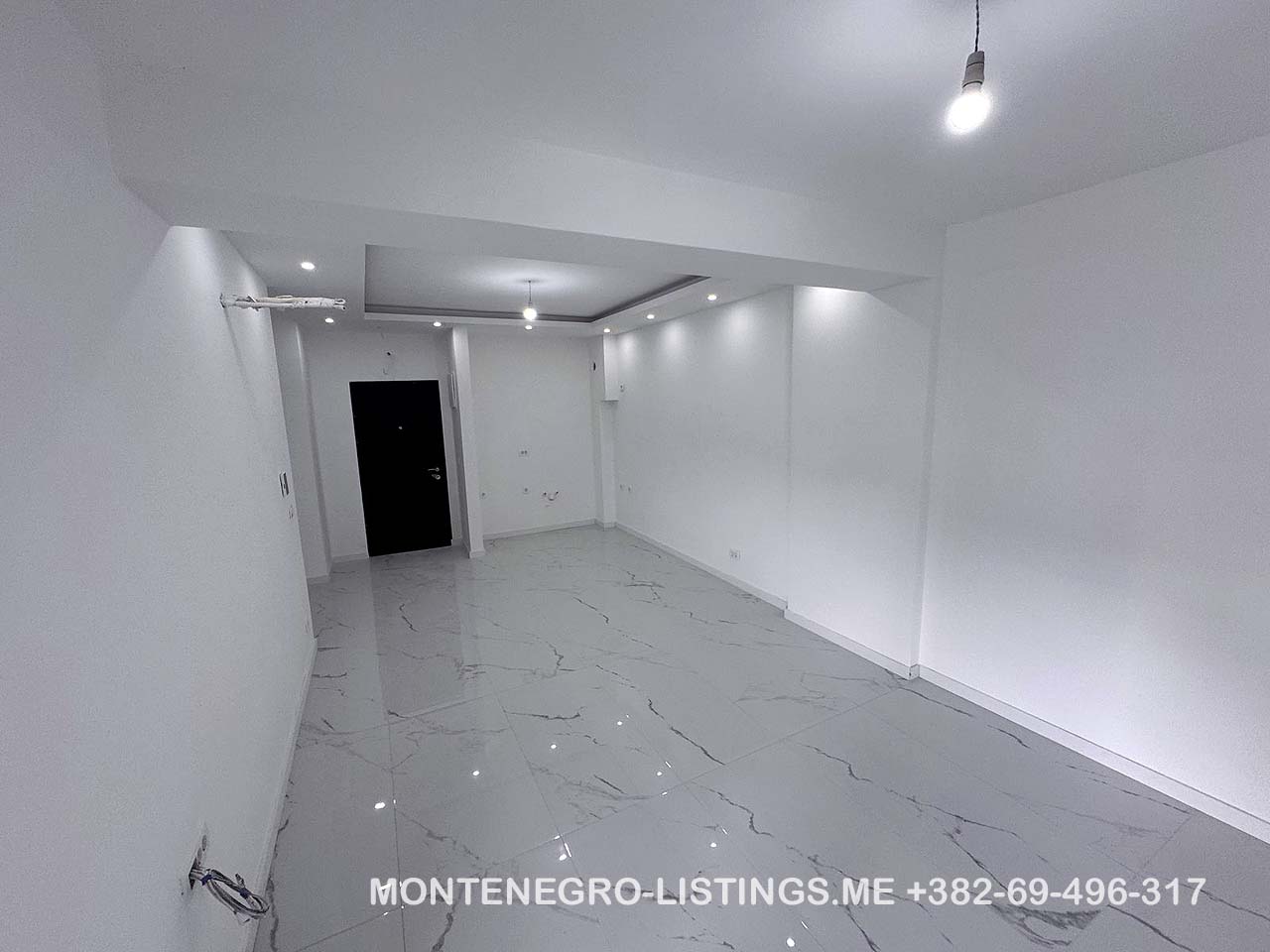 Stunning modern white space with glossy floors and recessed lights&mdash;perfect Ulcinj, Montenegro real estate. montenegro-listings.me by Ekosphere doo.