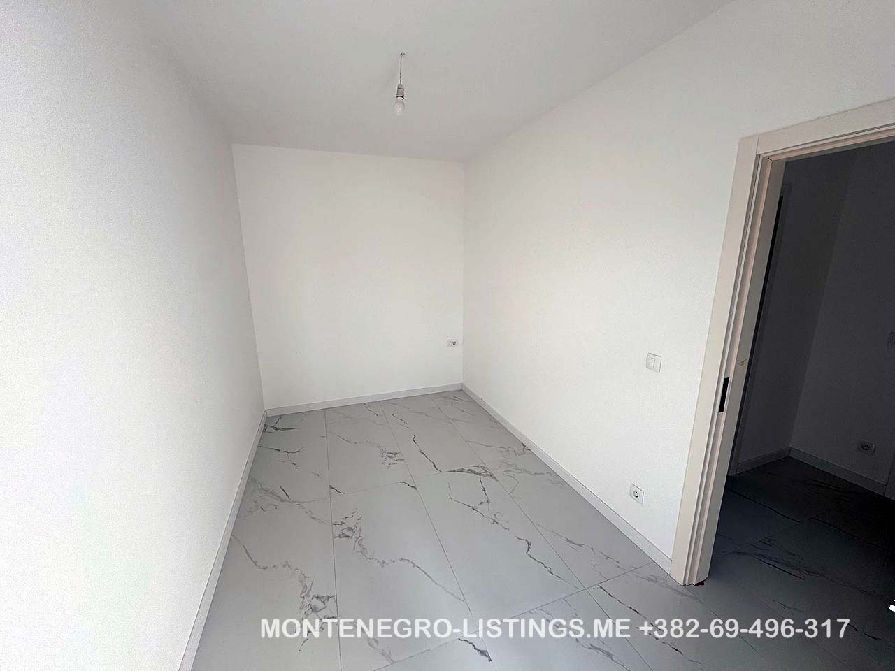 Bright, modern room with white walls and marble tiles in Ulcinj&mdash;prime real estate investment from montenegro-listings.me by Ekosphere doo.