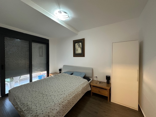 Modern Ulcinj property with a stylish bed, two wooden nightstands, large windows; exclusive listing by montenegro-listings.me ekosphere doo.