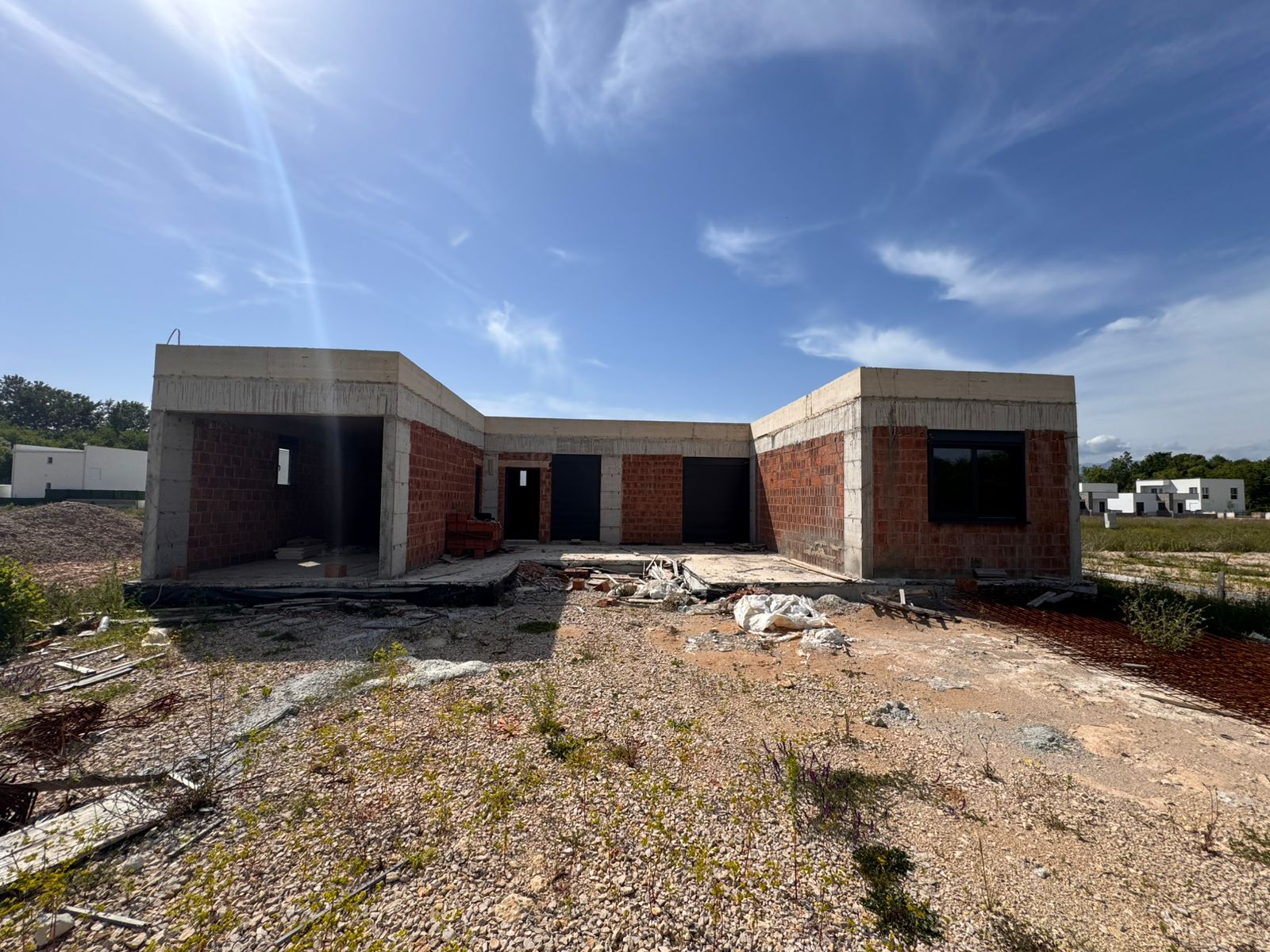 Unfinished single-story brick home on a spacious lot in Ulcinj, Montenegro—ideal real estate investment by Ekosphere, via montenegro-listings.me.