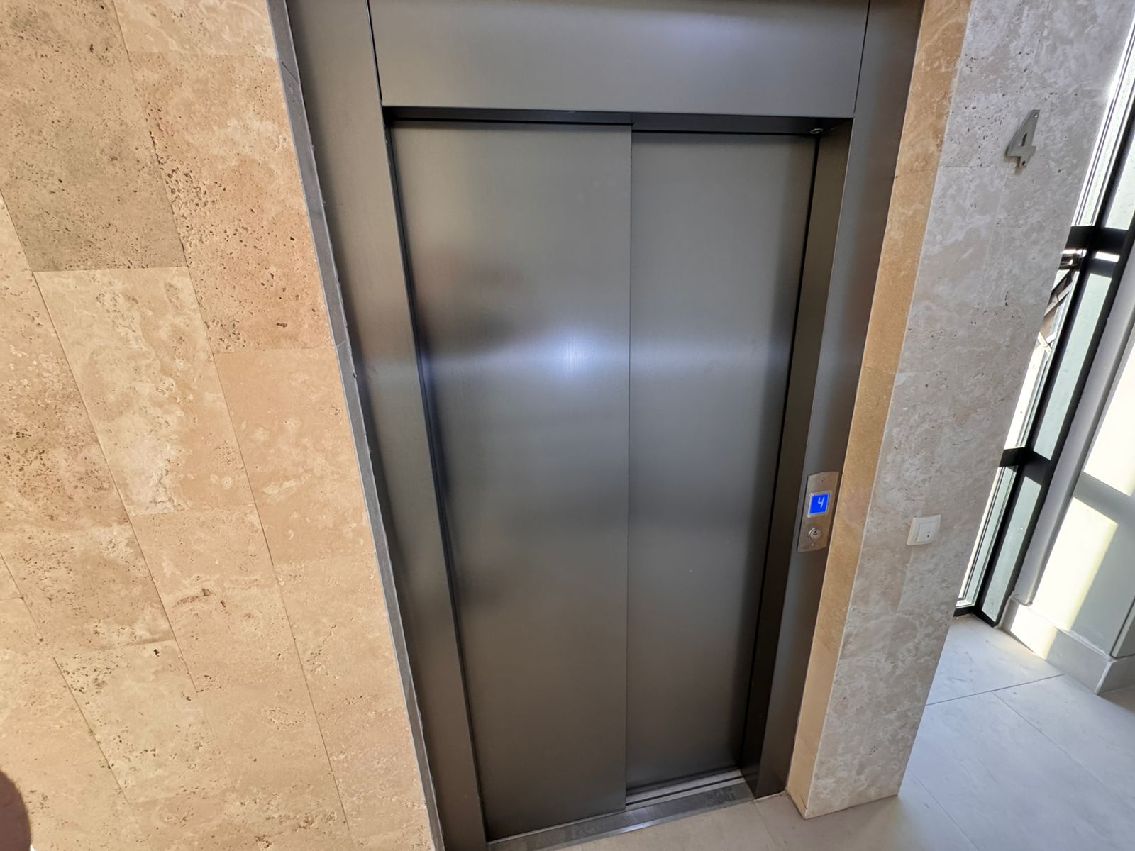 Modern stainless steel elevator, stone corridor, and premium amenities in Ulcinj real estate. Invest at montenegro-listings.me by ekosphere doo.