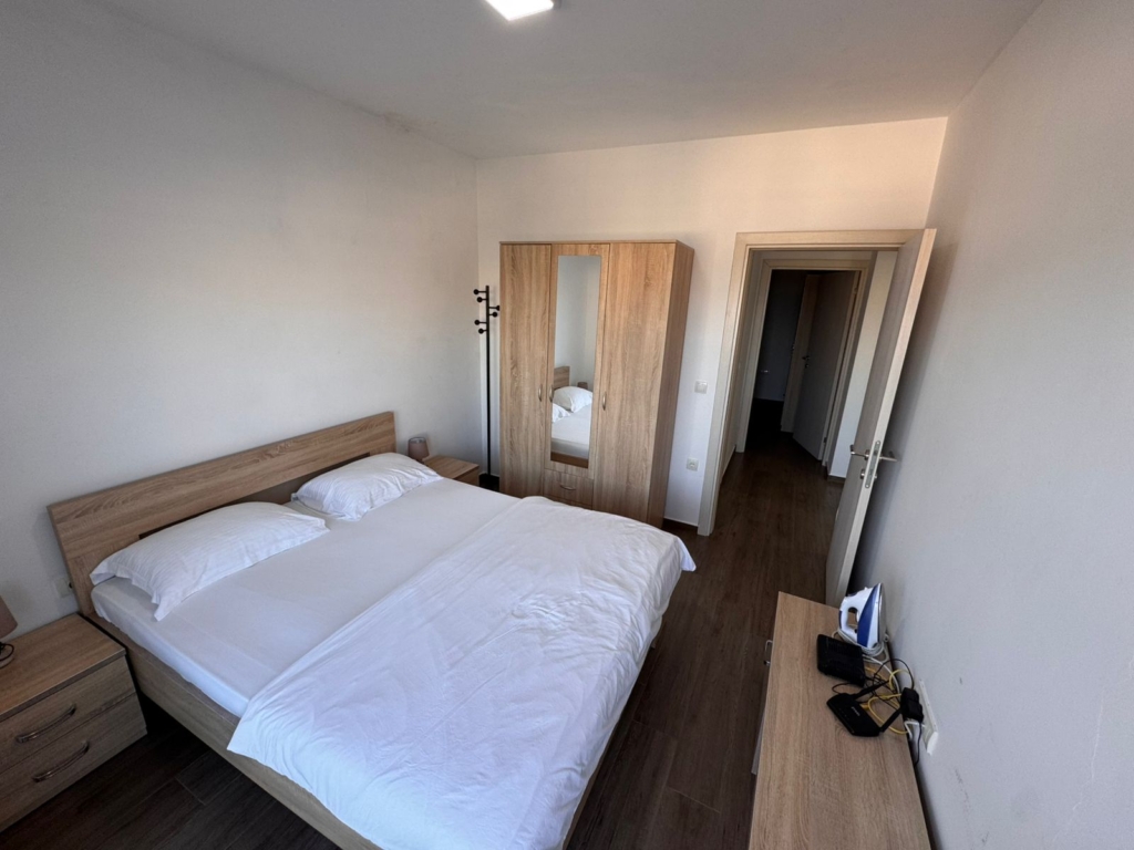Modern Ulcinj property for sale: bright bedroom with double bed, wardrobe, and more. Listed on montenegro-listings.me by ekosphere doo.