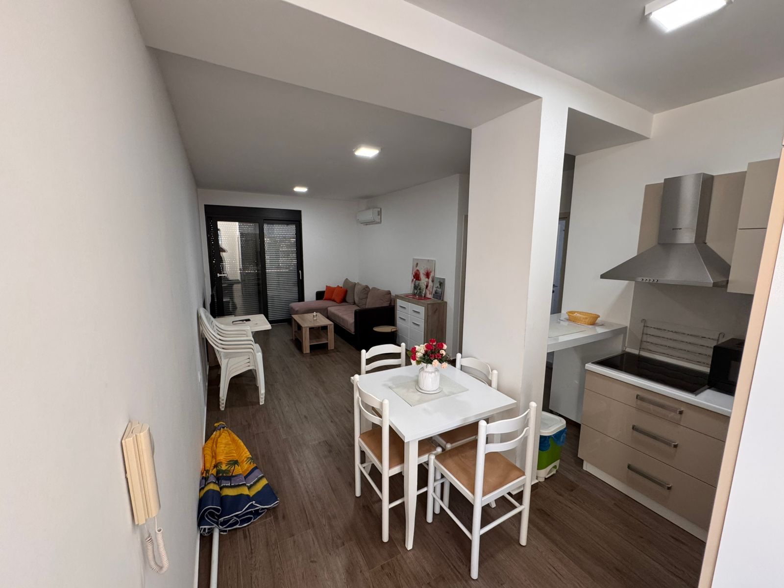 Stylish Ulcinj apartment for sale: modern open kitchen, dining area, bright living space by sliding doors&mdash;on montenegro-listings.me by Ekosphere.