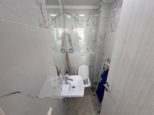 Stylish Ulcinj bathroom with marble walls, modern fixtures—ideal Montenegro investment. Exclusive on montenegro-listings.me by ekosphere doo.