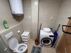 Modern bathroom in Ulcinj real estate: toilet, washing machine, water heater. Quality Ekosphere tiling. Montenegro-listings.me exclusives.