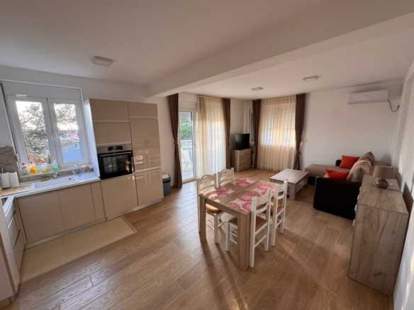 Stunning open-plan living in Ulcinj, Montenegro—modern kitchen, dining for six, bright lounge. Listed on montenegro-listings.me by ekosphere doo.