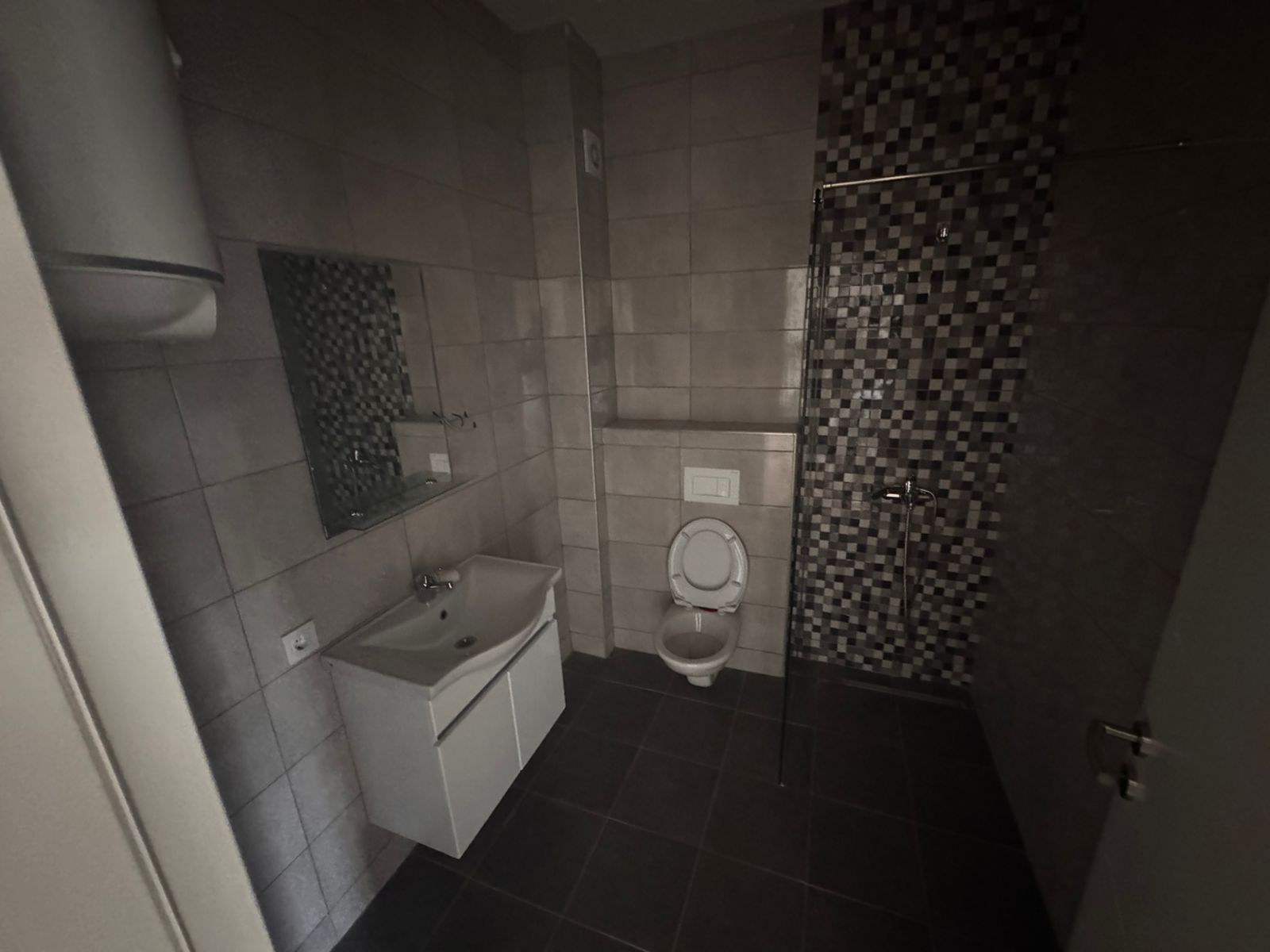 Stylish modern bathroom in Ulcinj real estate&mdash;tiled walls, sleek fixtures, walk-in shower. Invest with ekosphere doo & montenegro-listings.me!.