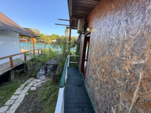 Discover investment potential in Ulcinj: modern Ekosphere property with wooden walkway, scenic greenery, and waterfront views—montenegro-listings.me.