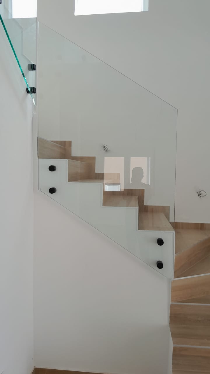 Elegant wooden staircase with glass railing, premium feature in Ulcinj properties. Invest via montenegro-listings.me by Ekosphere doo.
