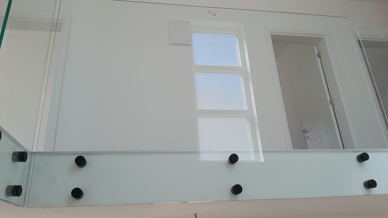 Modern glass railing with black hardware, sleek white wall, door, and window&mdash;ideal Ulcinj investment. Exclusive on montenegro-listings.me by ekosphere doo.