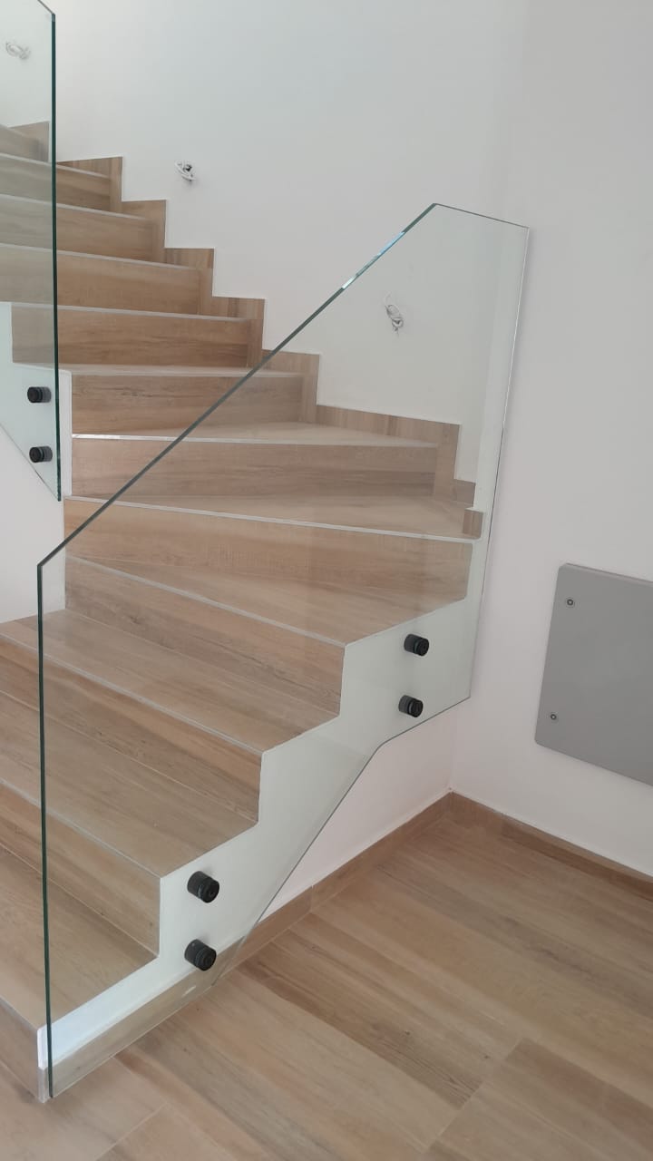 Sleek light-wood staircase with glass railings, ideal for luxury Ulcinj real estate. See more at montenegro-listings.me by ekosphere doo.