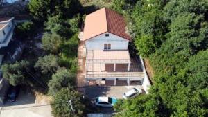 Exclusive two-story house with red roof, spacious terrace & parking in lush Ulcinj hills—prime investment by Ekosphere on montenegro-listings.me.