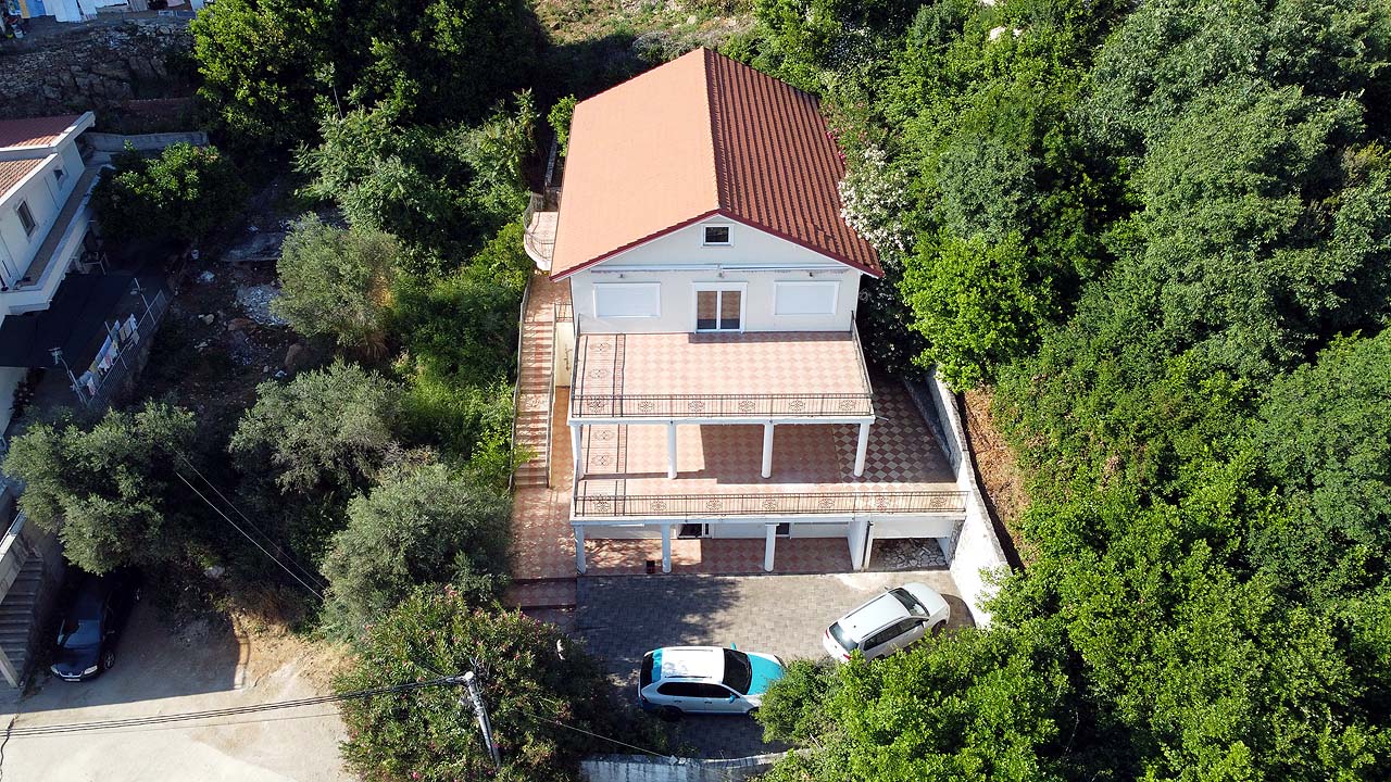Exclusive two-story house with red roof, spacious terrace & parking in lush Ulcinj hills—prime investment by Ekosphere on montenegro-listings.me.