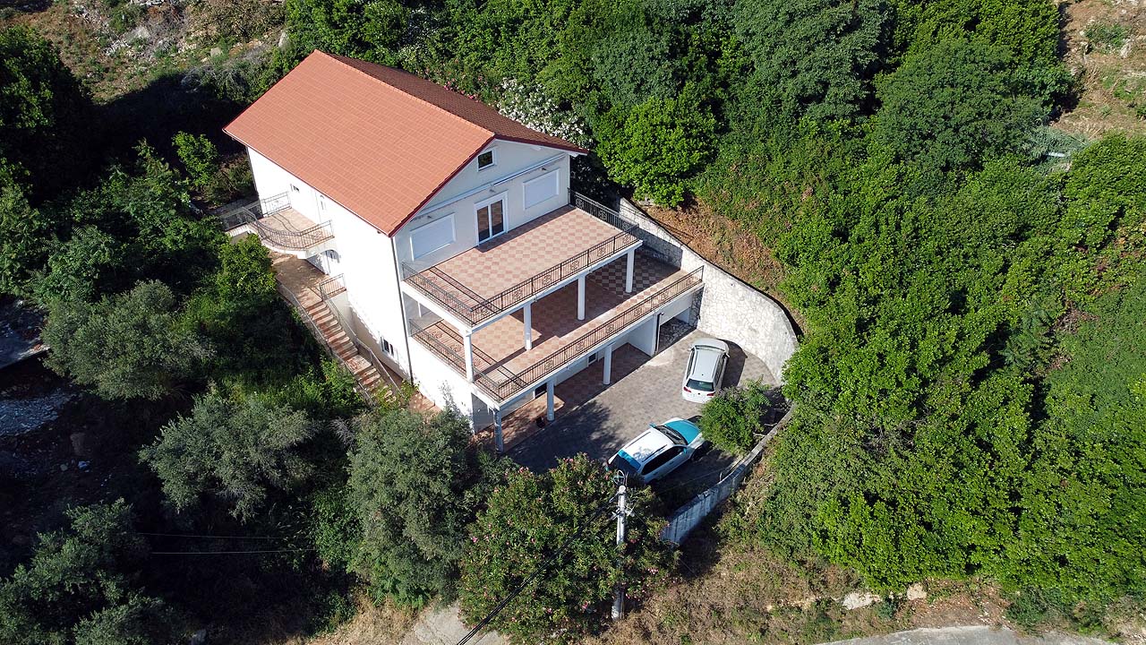 Exclusive Ulcinj villa: two-story white home with red roof, large terraces, private parking in lush greenery—only on montenegro-listings.me by Ekosphere doo.