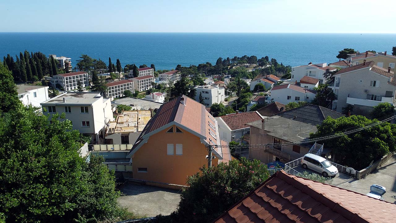 Stunning Ulcinj real estate: hillside homes with red-tiled roofs, sea views, lush trees—prime investment via montenegro-listings.me (ekosphere doo).