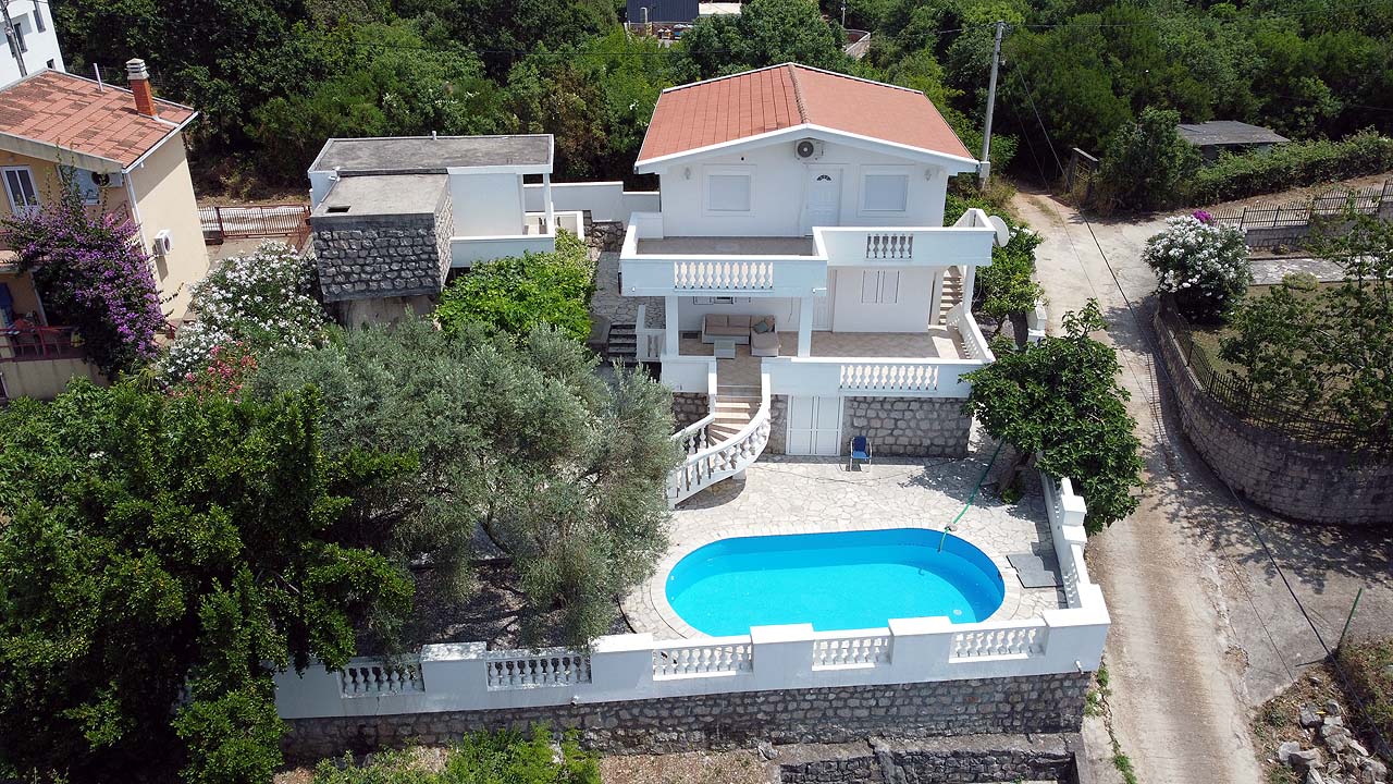 Premium two-story villa in Ulcinj, Montenegro with red roof, balcony, private pool and stone-walled yard. Eksophere doo project.