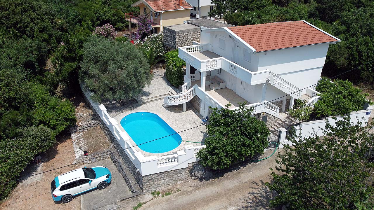 Stunning Ulcinj villa: white two-story home, red roof, pool, balcony, lush grounds. Prime investment at montenegro-listings.me by Ekosphere.