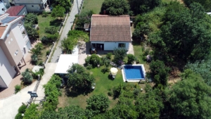 Exclusive Ulcinj property: red-tiled villa with lush garden, pool, and pathways. Top Montenegro real estate—montenegro-listings.me by ekosphere doo.