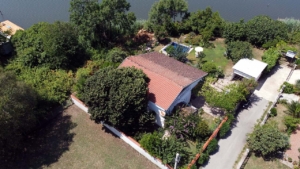 Stunning Ulcinj villa with red-tiled roof, lush garden, private patio & water views—exclusive on montenegro-listings.me by Ekosphere DOO.