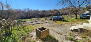 Spacious concrete yard with central well, parking, and growth potential in Ulcinj. Listed on montenegro-listings.me by ekosphere doo.