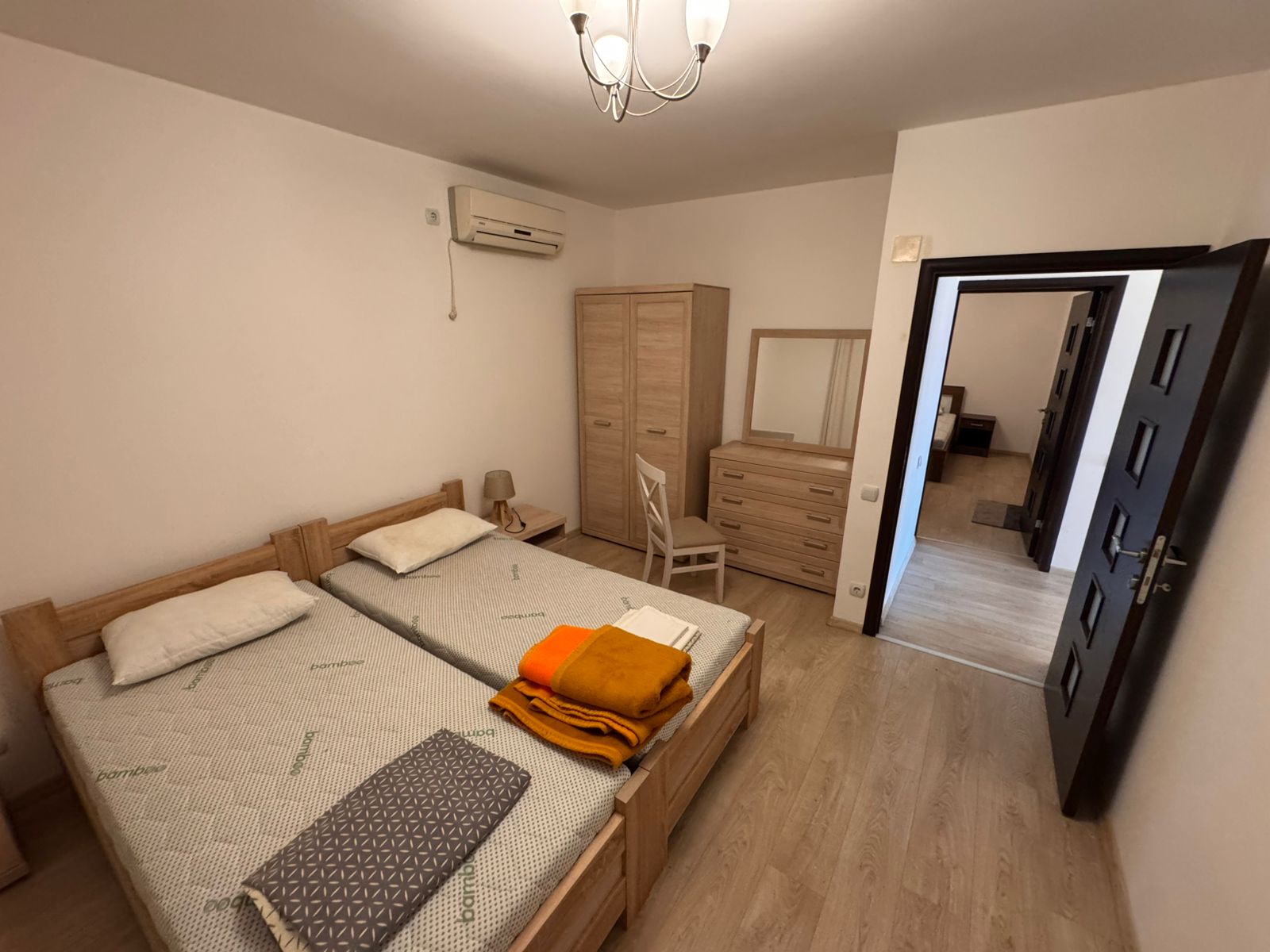 Modern Ulcinj bedroom for sale—2 beds, wood flooring, AC, eco-friendly by ekosphere doo. Top real estate at montenegro-listings.me.