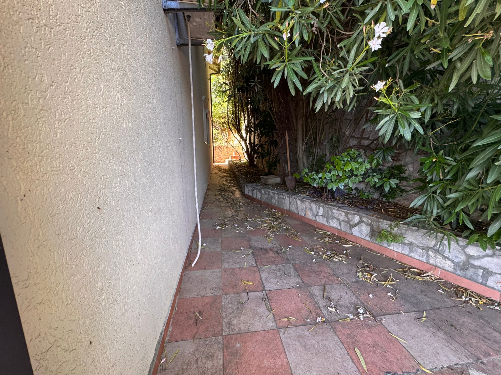 Charming tiled pathway in Ulcinj, Montenegro&mdash;ideal for serene living or investment. Listed on montenegro-listings.me by ekosphere doo.