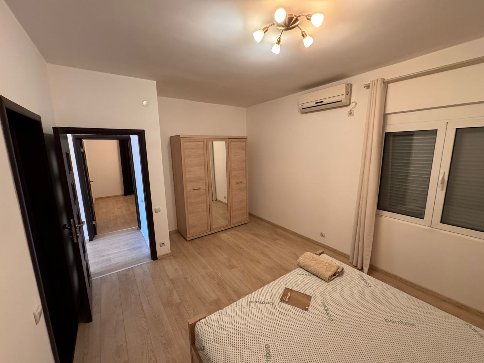 Modern Ulcinj bedroom for sale: wooden floors, mirrored wardrobe, AC. Invest with montenegro-listings.me by Ekosphere doo.