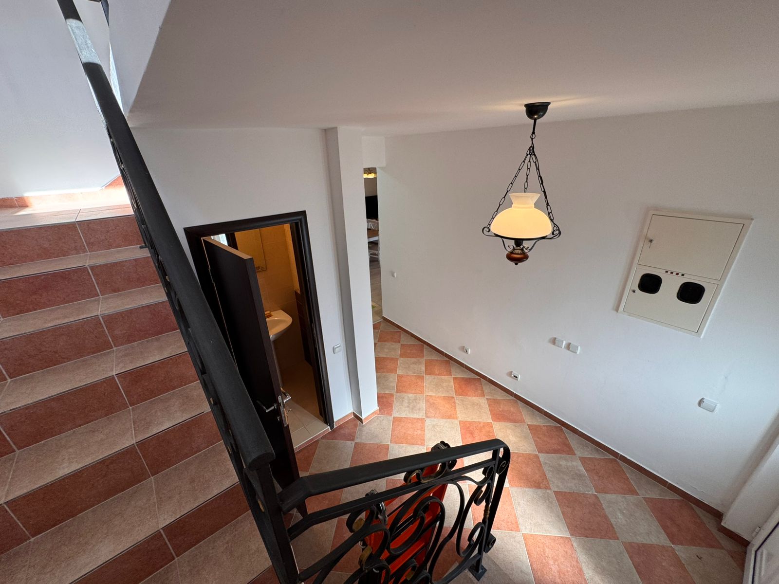 Elegant staircase view of an Ulcinj property with stylish tiles, metal rails, and open doors&mdash;exclusive on montenegro-listings.me by Ekosphere doo.