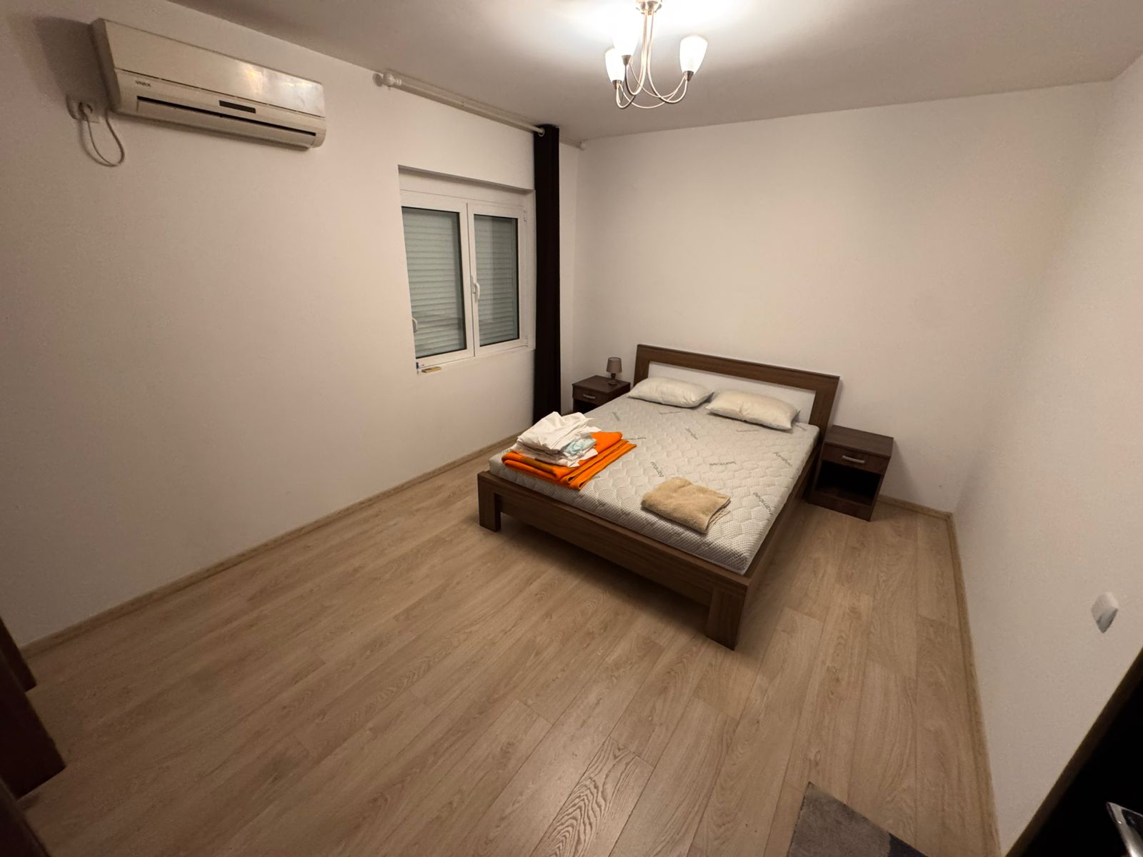 Modern minimalist bedroom in Ulcinj, Montenegro with double bed, AC, stylish flooring&mdash;ideal property investment at montenegro-listings.me.